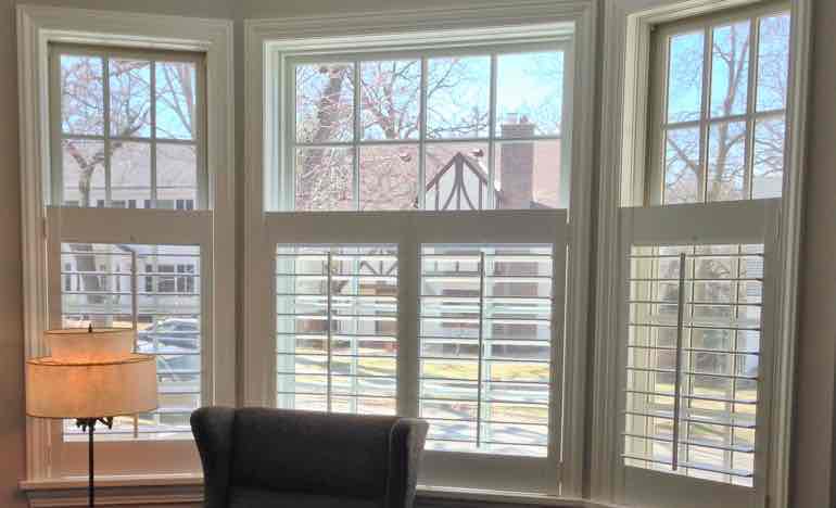 Half insulating shutters in family room bay window.